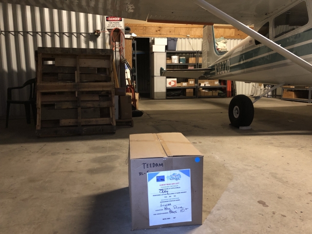 Cessna in hangar with donations